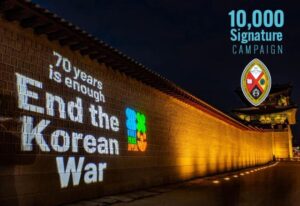 Projection on a wall: 70 Years is Enough! End the Korean War.