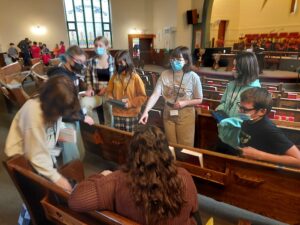 Kids in church pews searching through Bibles
