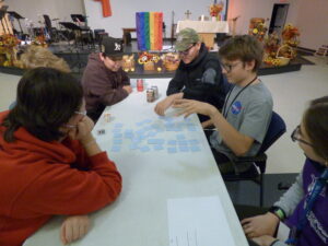 Group of youth sitting at a table playing the memory game