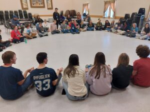 Youth sitting on floor in circle
