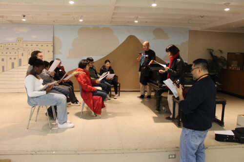 Medium size group learning and singing a Filipino song