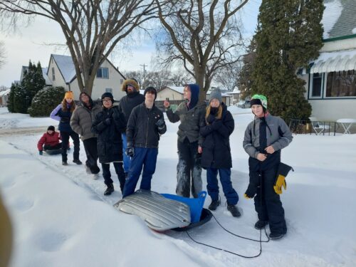 Group of youth coming back from sledding