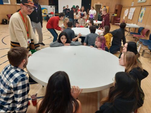 Youth playing minute to win it games around a table