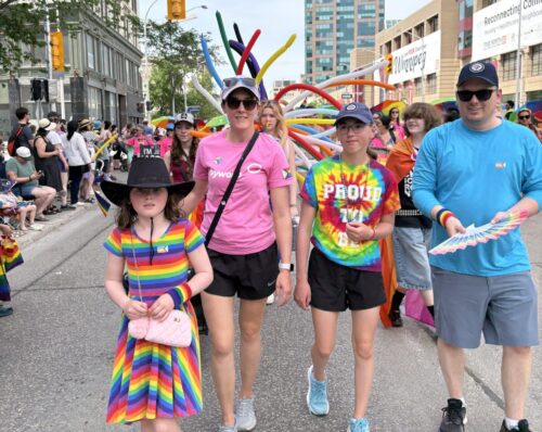 Colourfully dressed people walking in parade